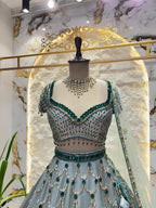 "ICY BLUE & EMERALD GREEN SCAPPLOPED LEHENGA"
