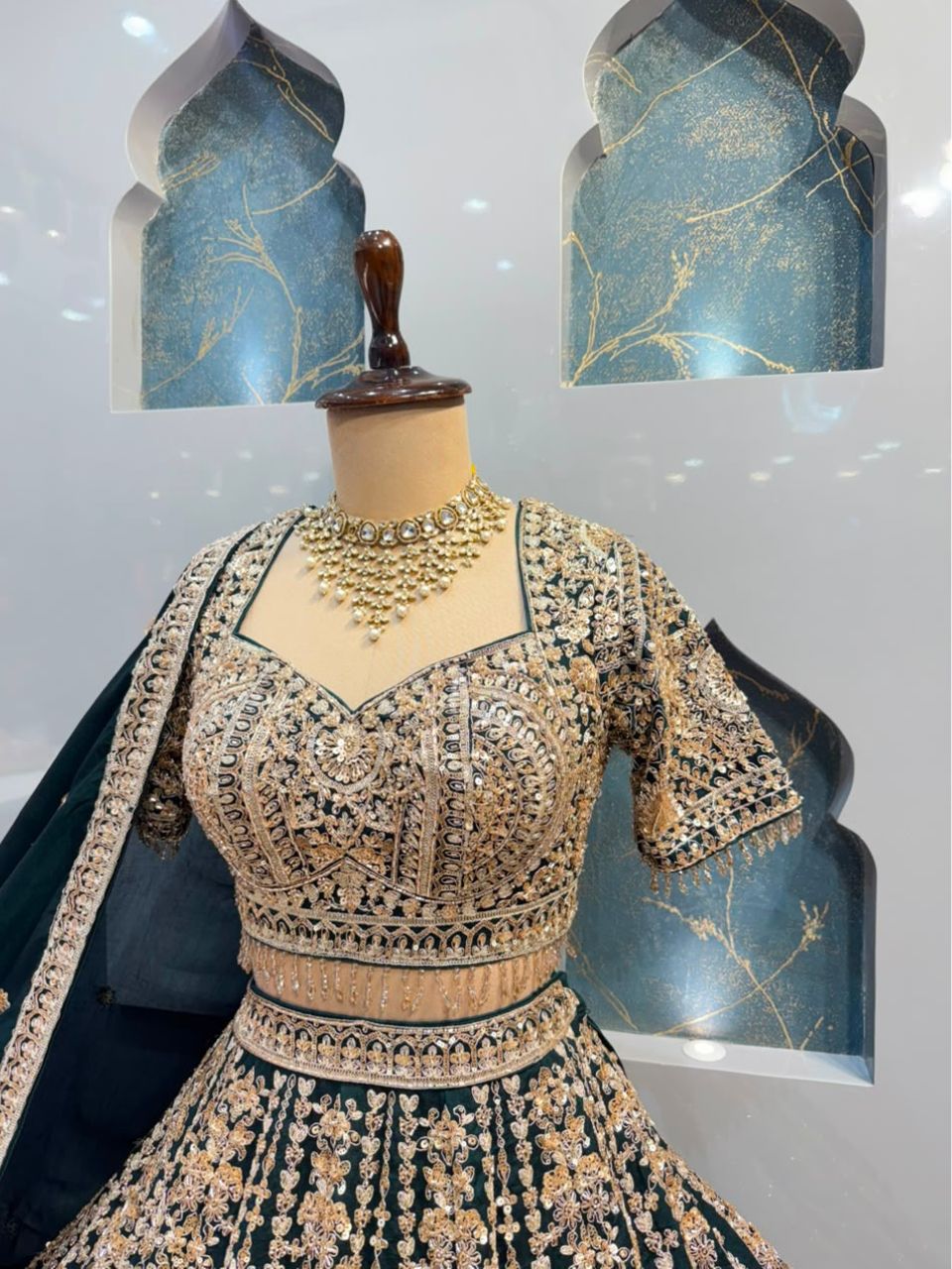 "EMERALD GREEN AND ANTIQUE GOLD EMBROIDERED LEHENGA"