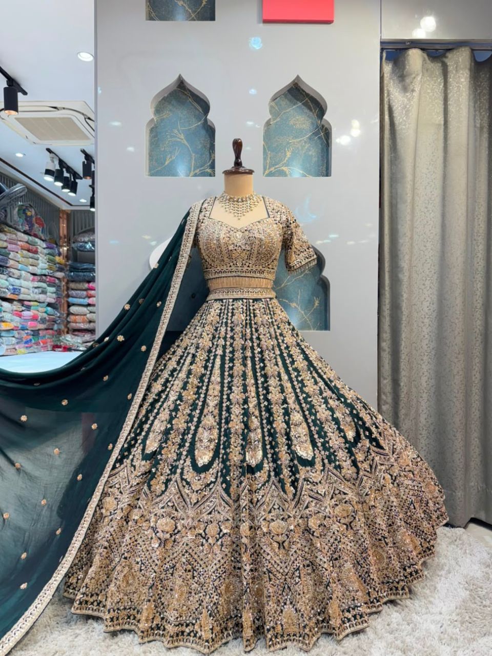 "EMERALD GREEN AND ANTIQUE GOLD EMBROIDERED LEHENGA"